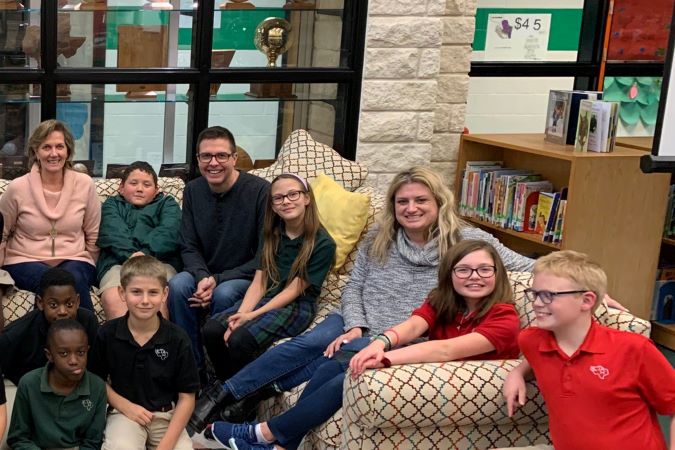 BNSF team members Susan Green, Jason Lamers and Andrea Power visit with children at Happy Hill Farm Academy in 2019.