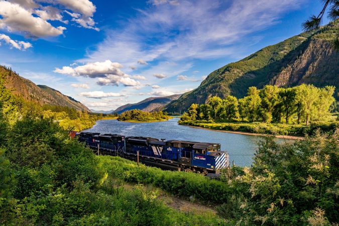 A MRL locomotive traveling through a mountain valley